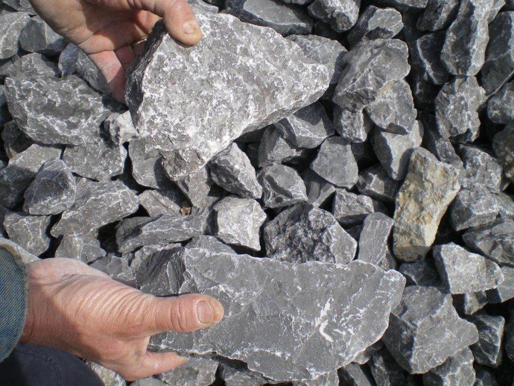 Gabion stone shown in a person's hands for scale